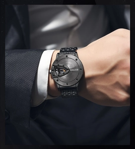 Macro shot of a black metal BESTWIN watch on a man's wrist in a business suit