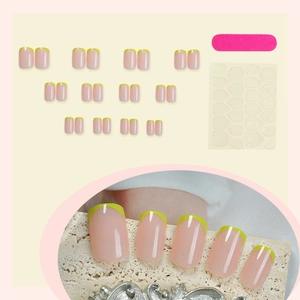 Short square press-on nails set with nude base and yellow French tips including tools
