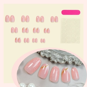 Set of 24 almond press-on nails in pink with white snowflakes and gold glitter stripes