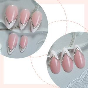 Elegant almond press-on nails with pink gradient, white V-shape tips and silver rhinestones