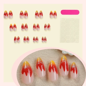 French press-on nails with red-yellow gradient glitter in long almond shape with tool kit