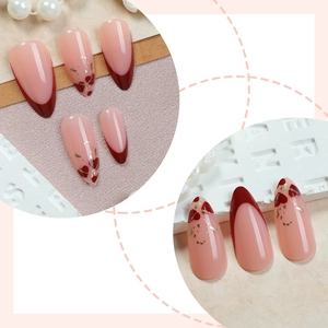 French heart press-on nails in almond shape with red tips and gold foil accents