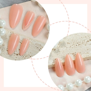 Glossy nude pink almond press-on nails with minimalist gold V-line accents for women