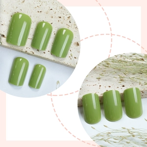 Olive green squoval press-on nails with glossy finish shown on stone background