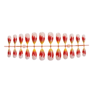 Long almond press-on nails with red and yellow gradient flame design and silver glitter