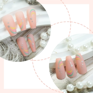 Matte pink coffin press-on nails with rainbow curved lines and silver glitter accents