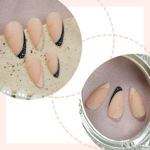 French almond press-on nails with nude matte base and gold glitter line accents