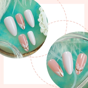 Glossy almond press-on nails with white leaf art and golden swirl designs
