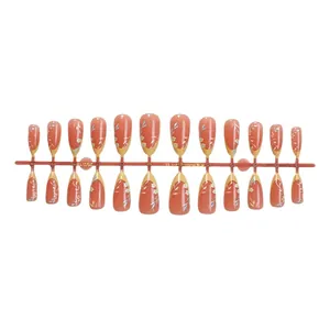 Set of 24 almond shape press-on nails with salmon pink base and small floral patterns