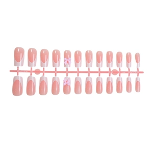 Handmade nude long press-on nails set with French tips and 3D pink bowknot accents