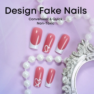 Pink heart design press-on nails with white French tips in a decorative layout