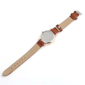 Macro view of watch back with brown alligator leather strap and silver metal buckle