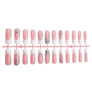 French tip press-on nails in pink with sparkling rhinestones and almond shape