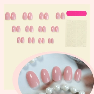 Short oval nude pink press-on nail kit with 24 gloss pieces and application tools
