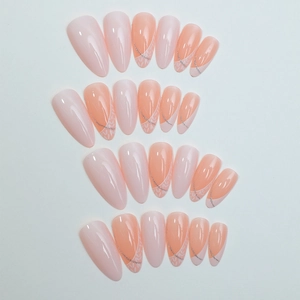 Faux ongles amande dégradé nude et corail avec dentelle blanche et paillettes argentées