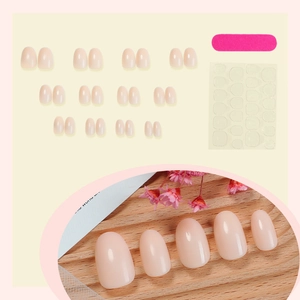 Short oval marble-style press-on nails in nude pink finish with complete tool kit