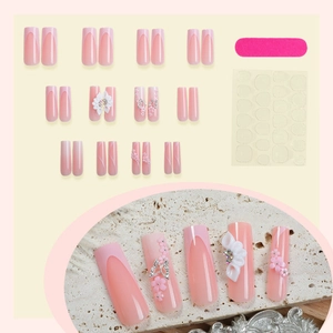 French press-on nails with 3D white flowers and butterfly accents on pink gradient base