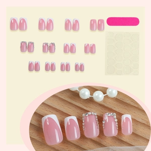 Pink French press-on nail kit with glitter rhinestones and manicuring accessories