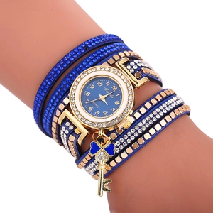 Détail de la montre à paillettes bleues multicouches avec pendentifs cœur et clé