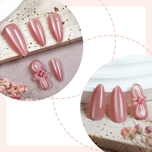 Glossy nude pink almond press-on nails with 3D flower carvings and pearl accents