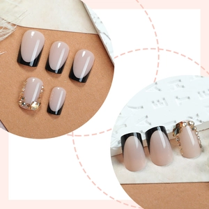 French black tip press-on nails with nude base and sparkling rhinestones accents