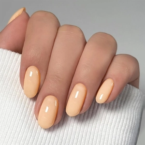 Short oval light apricot glossy press-on nails with marble solid color and high shine