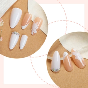 Almond-shaped press-on nails set with rhinestones and white floral patterns
