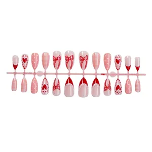 Sweet Valentine almond press-on nails with red bows, hearts and polka dot patterns