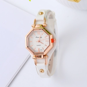 Detail of octagonal rose gold case with white leather strap and gold rivet accents