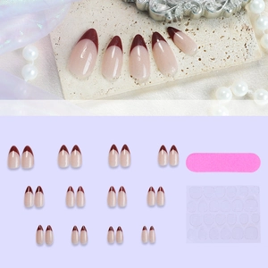 Brown almond press-on nails with burgundy French tips and manicure tool set