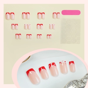 French tip press-on nail kit with red heart designs and adhesive tabs for women