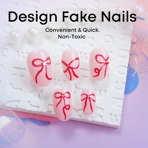 Pink press-on nails with red ribbon bow designs and pearl accents for Valentine