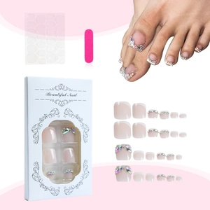 Sparkling French tip press-on toenails in pink with rhinestones and full tool kit