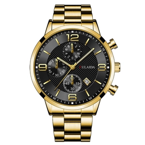 Detail of gold stainless steel watch with black textured dial and chronograph sub-dials