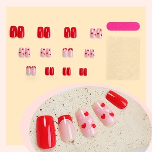 French almond press-on nails set with red hearts and minimalist solid color design