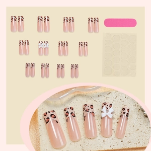 Leopard print press-on nails with 3D white bows and pink base, French tip style set