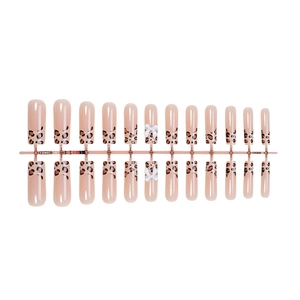 Long square leopard print press-on nails with 3D white bow tie on nude base color
