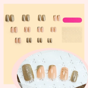 Almond press-on nails set in nude pink with gold glitter and geometric line art