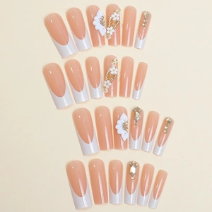 Press-on nails featuring long coffin shape with French tips, 3D flowers and gold butterflies