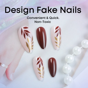 Almond shaped press-on nails with brown color and autumn leaf patterns on fabric