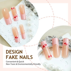 Pink long ballet fake nails with red hearts and French tips on decorative background