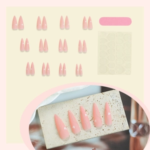 Pink long almond press-on nails with white heart and wavy line designs, full DIY kit