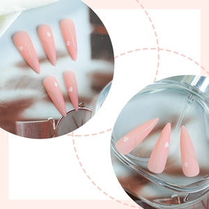 Long stiletto press-on nails in matte pink with white heart and wave line designs