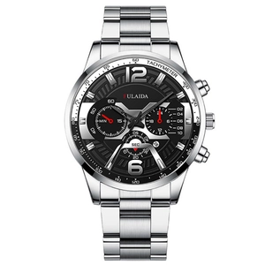 Detail showing a silver men's chronograph watch with a black dial and date display