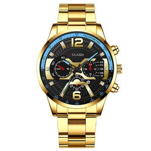 Detail of men's gold stainless steel watch with black dial and blue tachymeter bezel