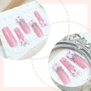Pink long coffin press-on nails with 3D bows, rhinestones and crisscross patterns