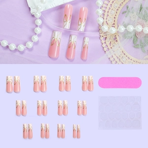 Pink and white French gradient press-on nails with golden bows and 24-piece toolkit