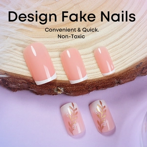 Short square press-on nails in nude peach with golden wheat and French tips