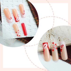 Long coffin press-on nails with red hearts and XO patterns for Valentine's day