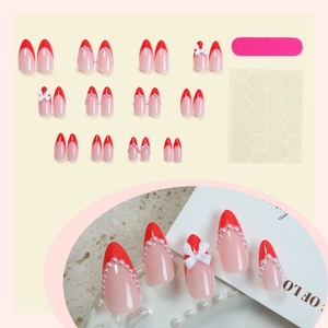 Faux ongles French rouges avec nœuds 3D blancs et perles, lime et adhésif inclus